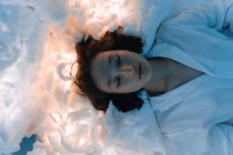 Woman Dreaming and sleeping on clouds