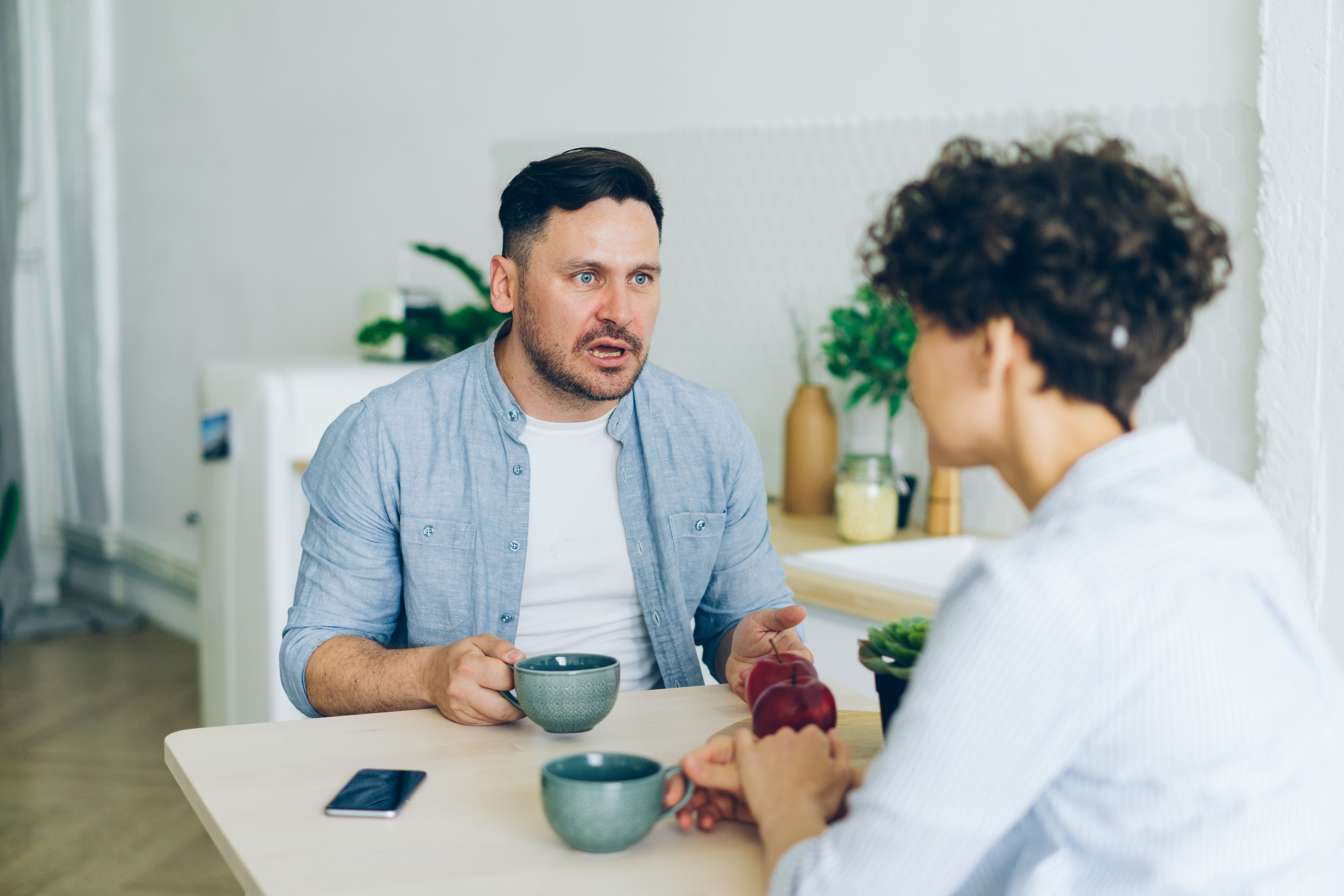 The Zodiac Signs Most Likely to Crave an Authentic ‘Girlfriend Energy’ Connection Couple having a thoughtful conversation over coffee at home.